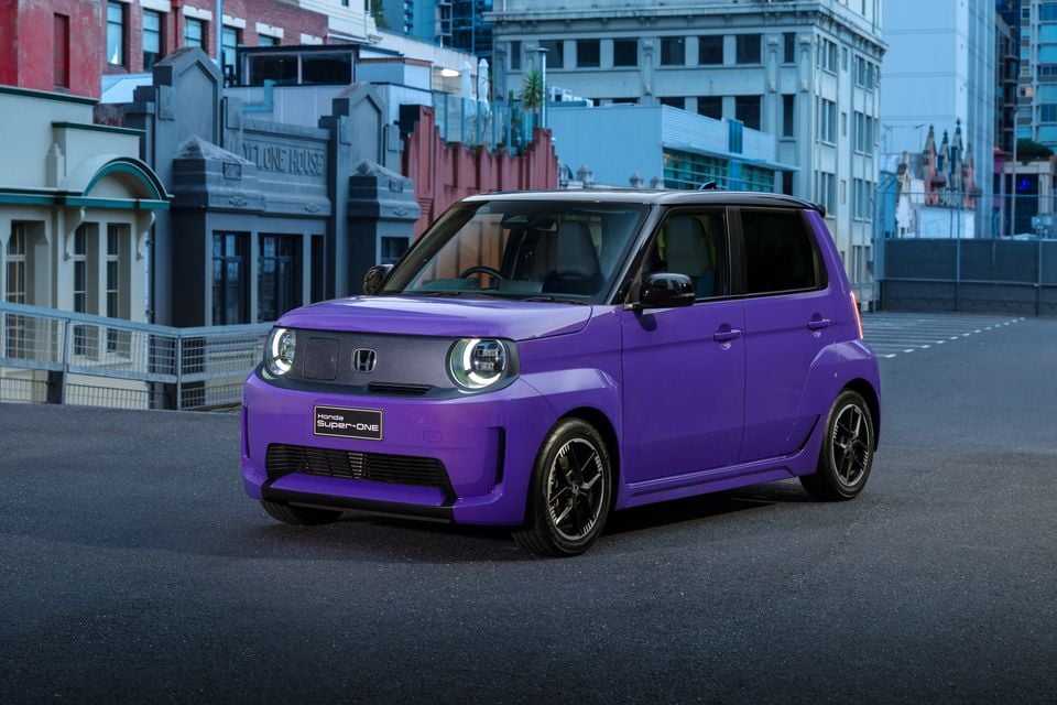A purple 2026 Honda Super-One electric hatchback parked on a city street, viewed from the front quarter.
