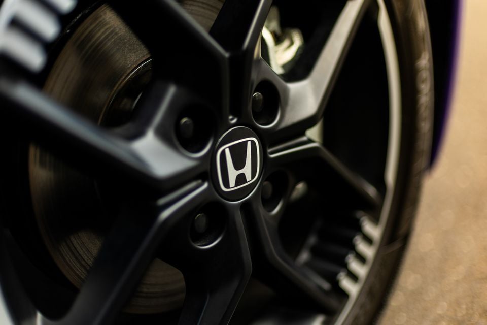 Close-up of a black alloy wheel with the Honda badge on the centre cap of a 2026 Honda Super One