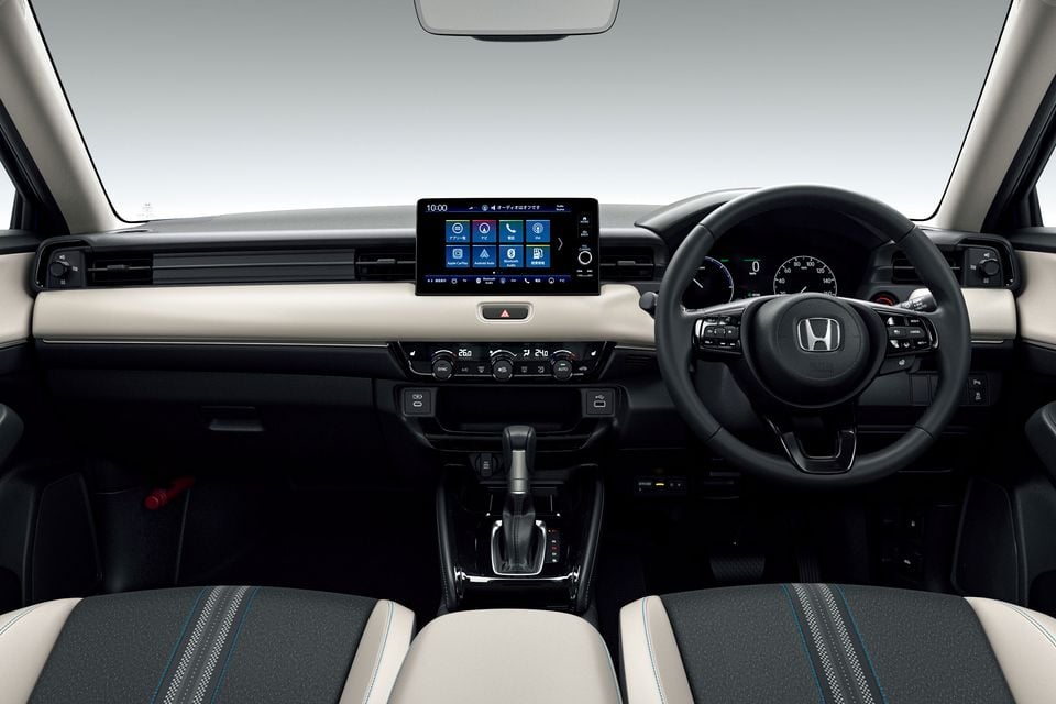 Dashboard of the 2026 Honda Vezel (HR-V) with a touchscreen, steering wheel, climate controls and a two-tone cream and black interior