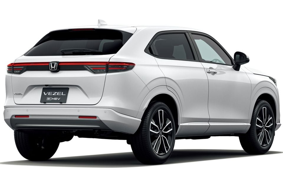 A white 2026 Honda Vezel e:HEV small SUV seen from the rear passenger side, against a white background