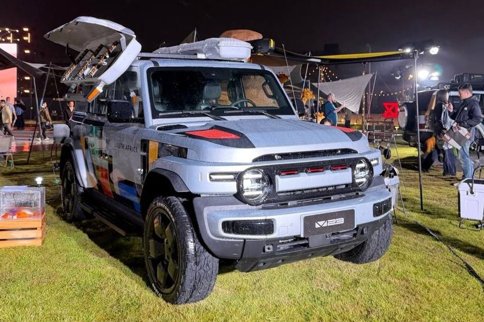 Grey iCaur V23 customised overseas display car, identified by its V23 plate, with roof-mounted outdoor equipment and accessories; not a V25 or confirmed Australian launch specification.