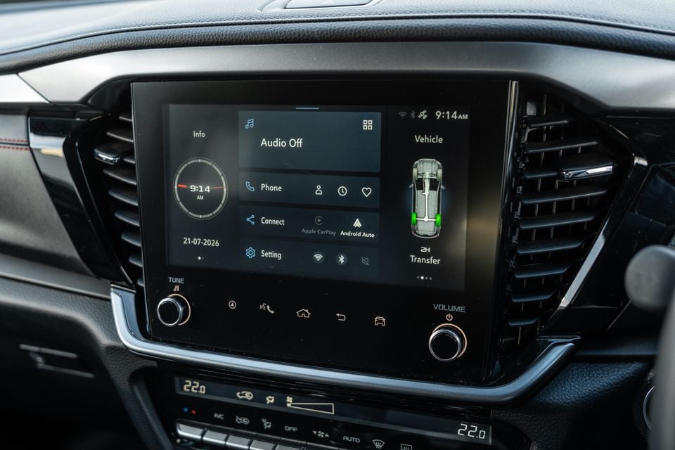 The touchscreen infotainment display of a 2026 Isuzu MU-X X-Terrain showing the home screen with Apple CarPlay, Android Auto, and 2H transfer mode indicated, with climate controls visible below.