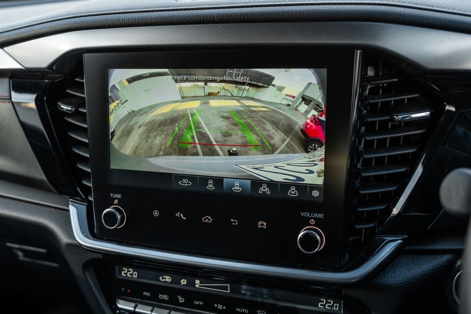 The reversing camera display on the touchscreen infotainment system of a 2026 Isuzu MU-X X-Terrain, showing parking guidelines and a car park behind the vehicle
