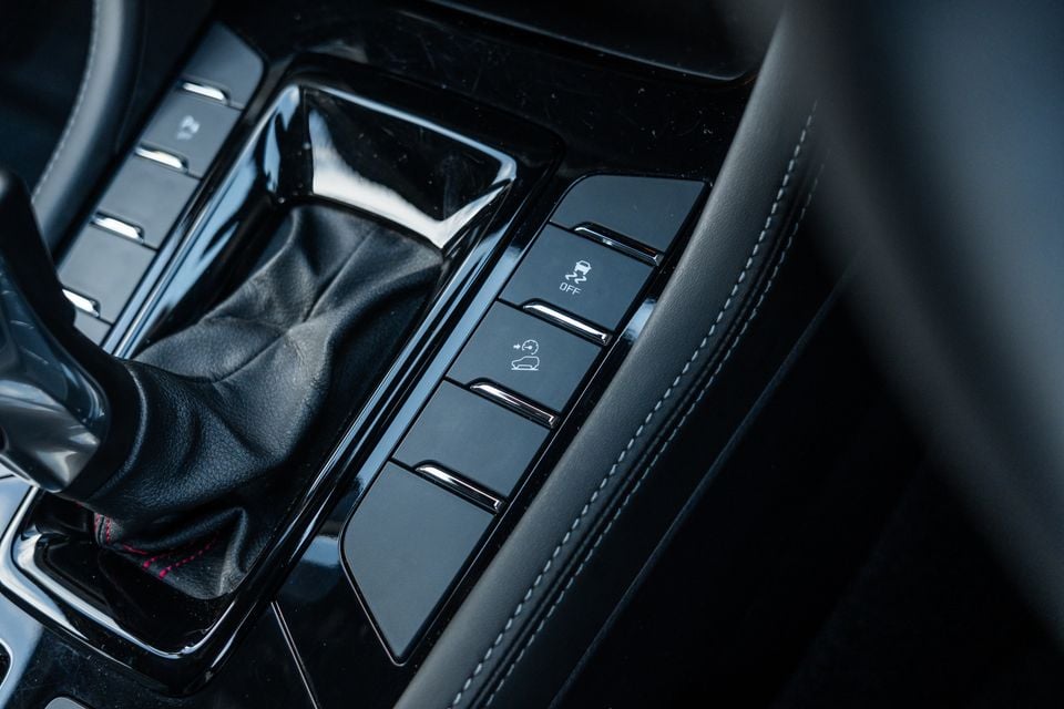Close-up of the centre console button panel and gear shifter in the 2026 Isuzu MU-X X-Terrain, showing traction control off and hill descent control buttons