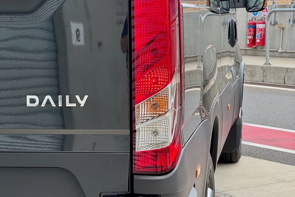 Close-up of the rear tail light and 'Daily' badge on a grey Iveco Daily van