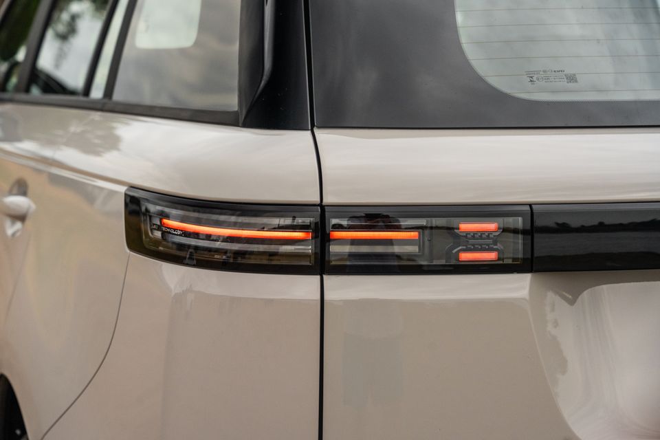 Close-up of the LED tail lights on a Jaecoo J5 EV in a light beige colour, showing the slim horizontal light bar design spanning the rear.