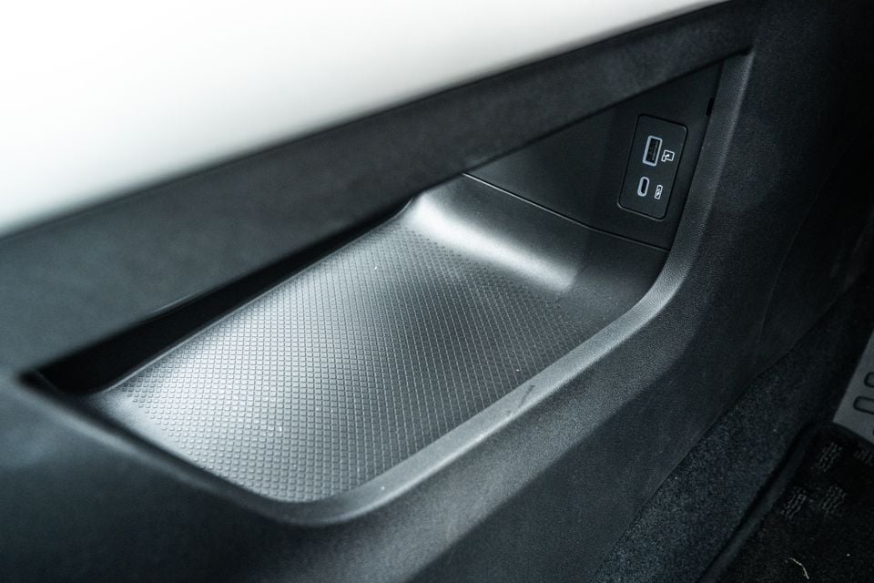 Close-up of a car door storage pocket with USB-A and USB-C charging ports on the inner panel, likely from a 2026 Jaecoo J5 EV.