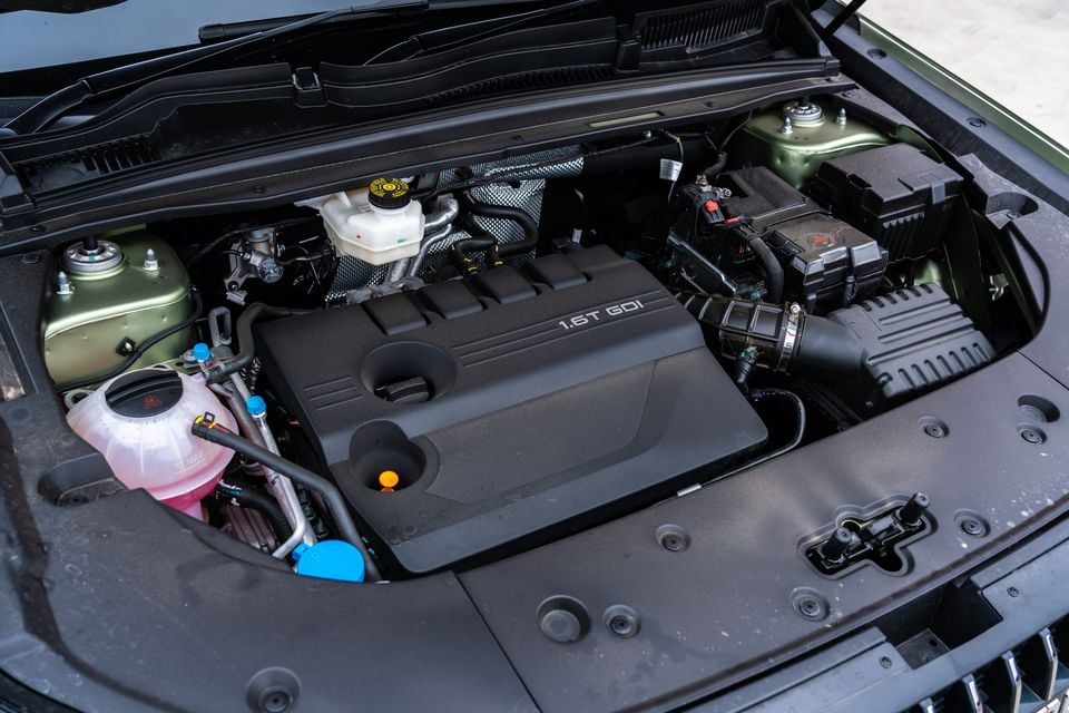 Engine bay of a Jaecoo J7 showing the 1.6T GDI turbocharged petrol engine