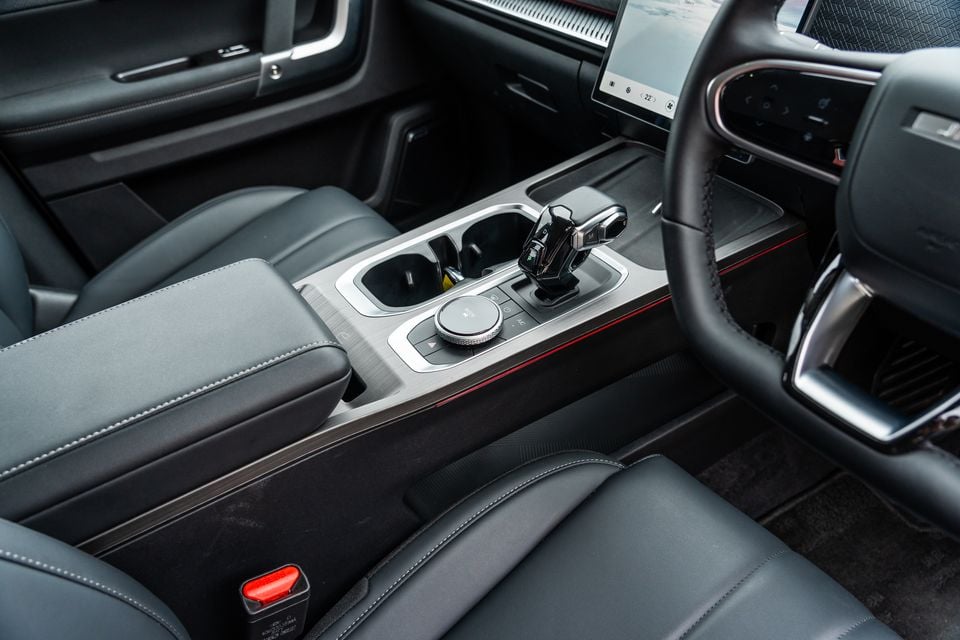 Interior centre console of the 2026 Jaecoo J7 showing the gear selector, cup holders, rotary controls and touchscreen infotainment display
