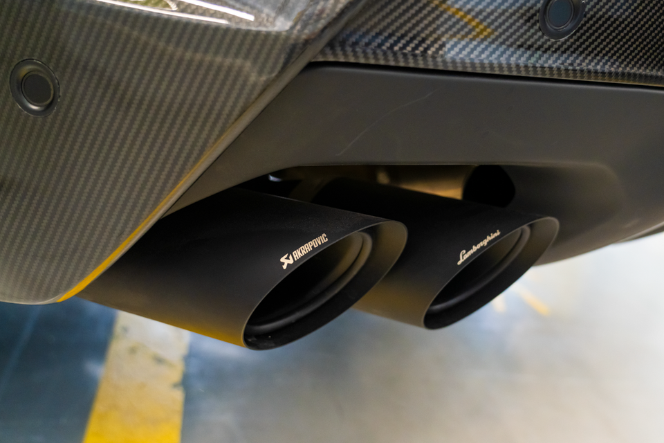 Akrapovic exhaust tips on a Lamborghini Urus Performante, viewed from below the carbon fibre rear diffuser