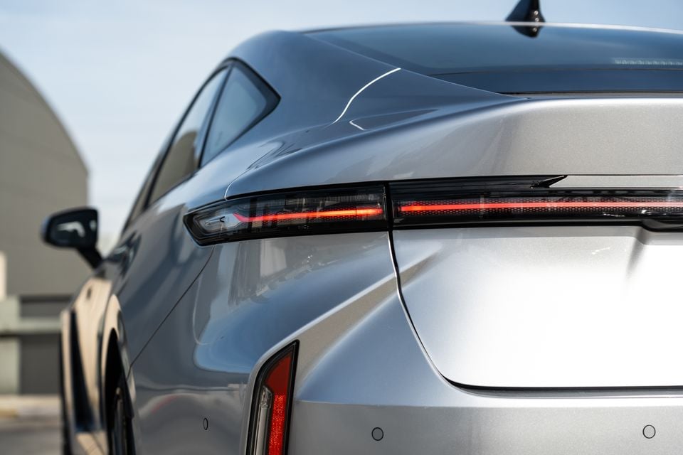 Close-up of the rear tail light on a silver 2026 Lexus ES350e, showing the slim LED light bar and sculpted bodywork.