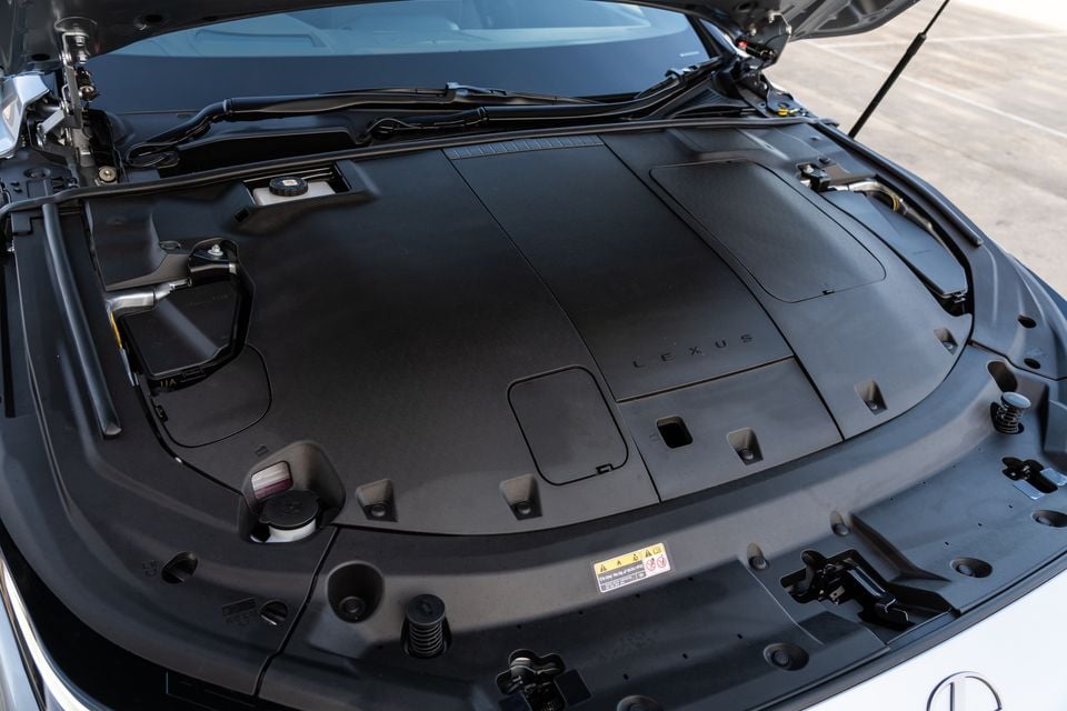 Engine bay of a Lexus ES350e with the bonnet open, showing a covered engine with a Lexus-branded plastic cover