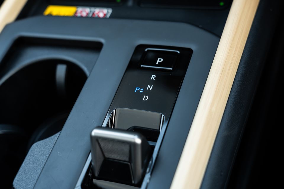 Close-up of the gear selector and centre console in the 2026 Lexus ES 350e, showing P, R, N and D positions with light wood trim accents.