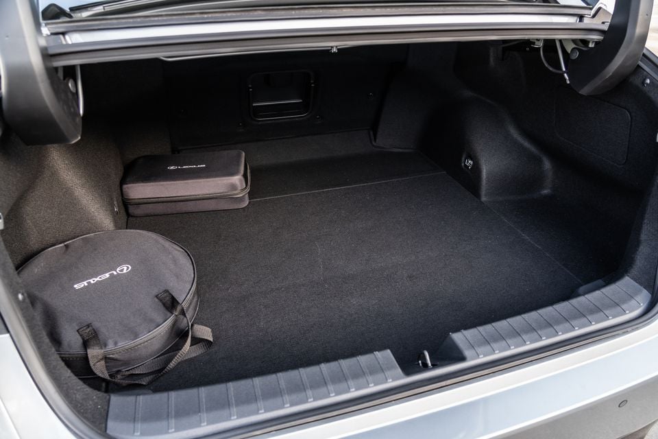 The open boot of a Lexus ES350e showing a carpeted cargo area with Lexus-branded spare tyre bag and toolkit case