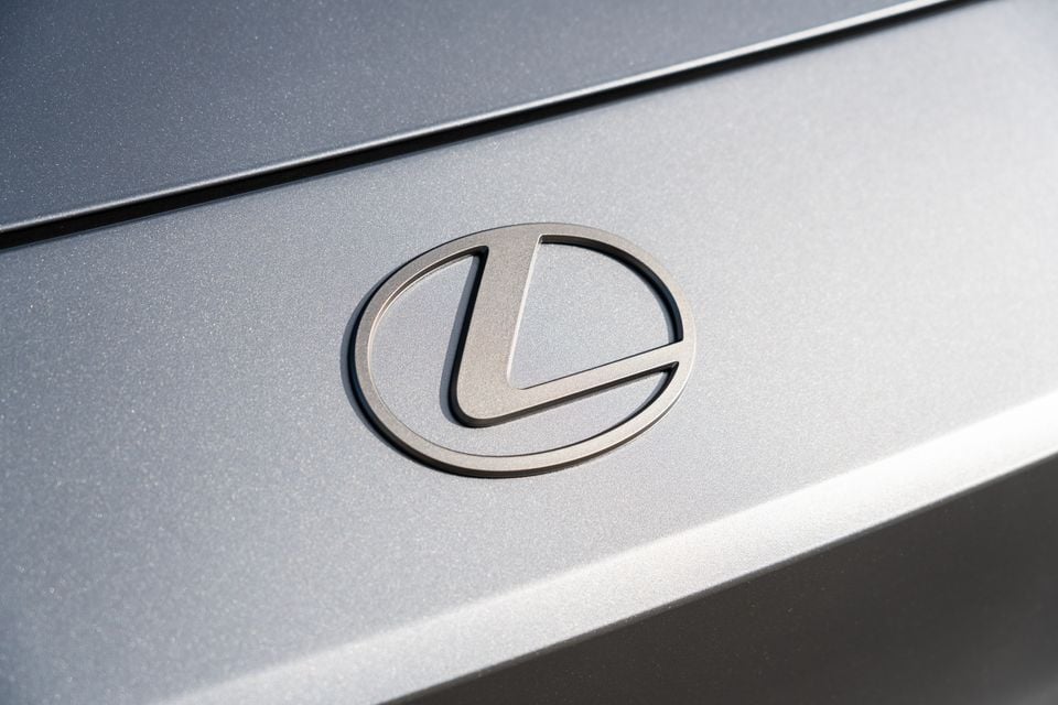 Close-up of the Lexus badge on the rear of a silver 2026 Lexus ES350e