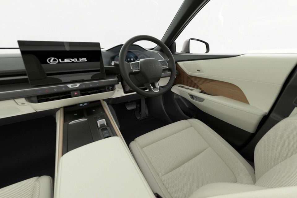 Lexus ES interior showing a large touchscreen infotainment display, cream leather seats, wood trim door panel, and steering wheel