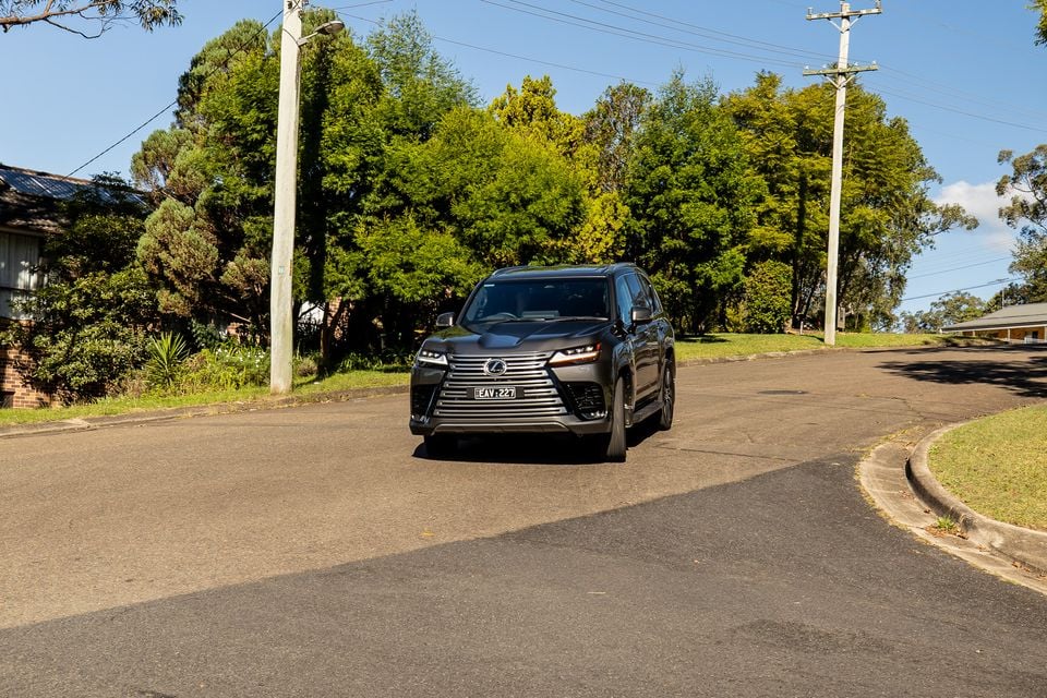 A dark grey 2026 Lexus LX700h Sports Luxury large SUV seen from the front on a suburban Australian street