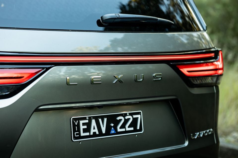 Close-up of the rear of a Lexus LX700h showing the Lexus lettering, tail lights, and Victorian number plate