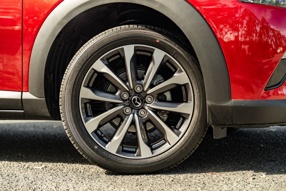 Close-up of a Toyo tyre on a dark multi-spoke alloy wheel of a red Mazda CX-3