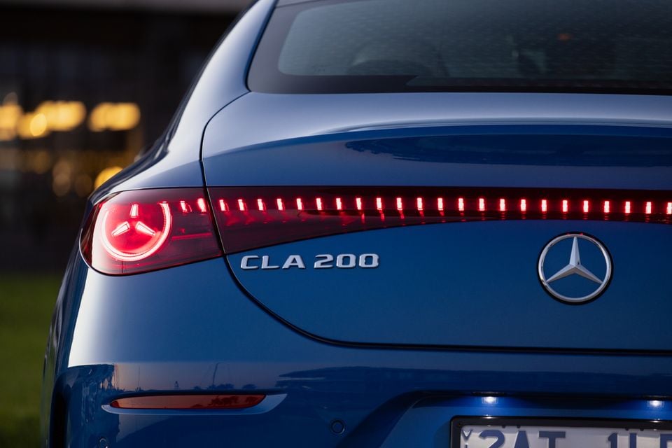 Rear of a blue Mercedes-Benz CLA 200 showing the LED tail-lights and three-pointed star badge
