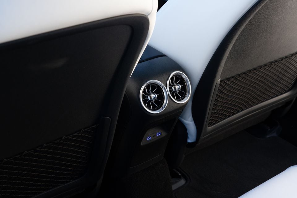 Rear passenger air vents with turbine-style blades and USB charging ports on the centre console of a 2026 Mercedes-Benz CLA 250 Electric