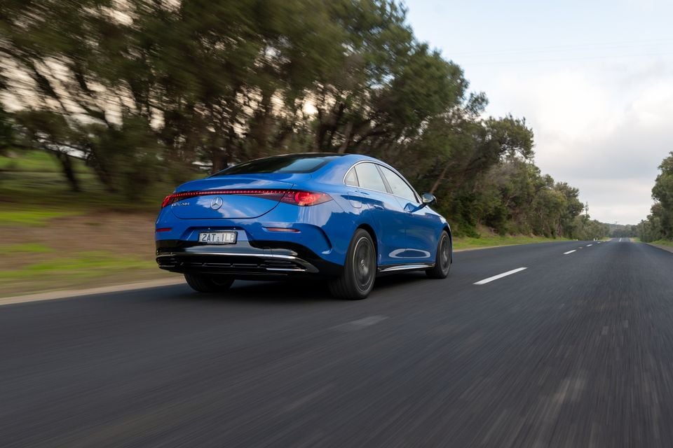 A blue 2026 Mercedes-Benz CLA 250 Electric sedan seen from the rear while driving on a country road in Australia