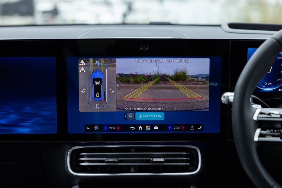 The infotainment touchscreen in a 2026 Mercedes-Benz CLA 250 Electric displaying a 360-degree parking camera view with a front camera feed and parking guidelines.