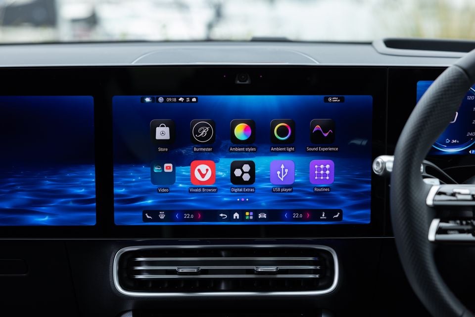 The Mercedes-Benz MBUX infotainment touchscreen in a 2026 Mercedes-Benz CLA 250 Electric, showing the app menu with options including Burmester, Ambient styles, Vivaldi Browser, and Apple CarPlay.