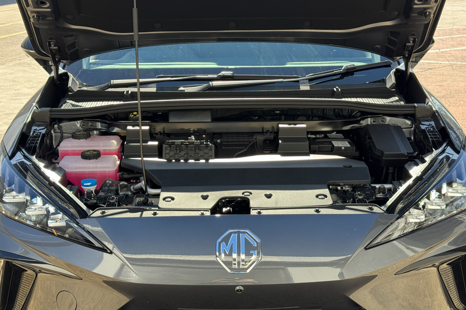 The engine bay of an MG4 EV with the bonnet open, showing fluid reservoirs and underbonnet components