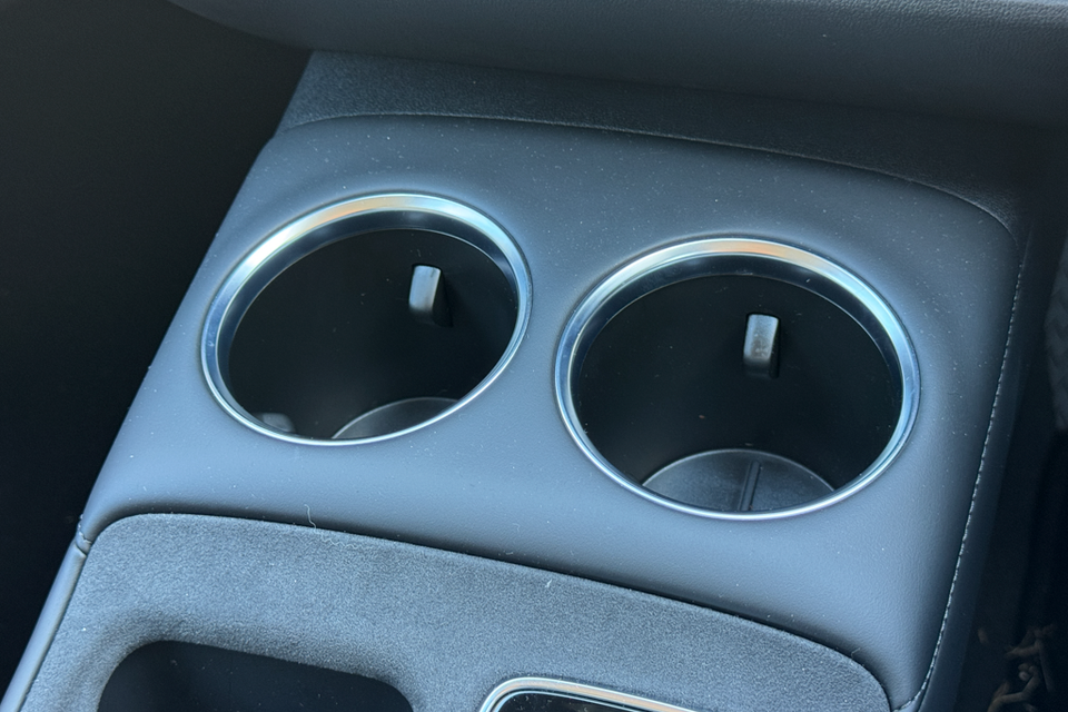 Two chrome-rimmed cup holders in the centre console of a 2026 MG4 EV