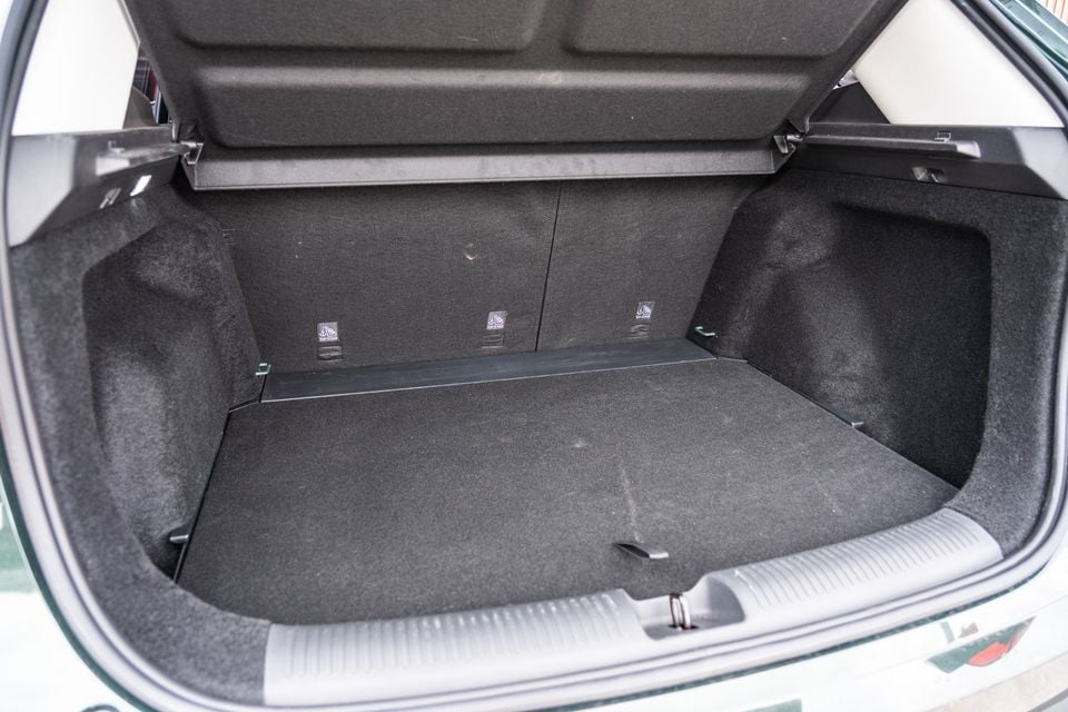 The empty boot of the 2026 MG ZS Essence Hybrid, showing a carpeted cargo area with a parcel shelf above and three top-tether anchor points visible at the rear of the seat backs.