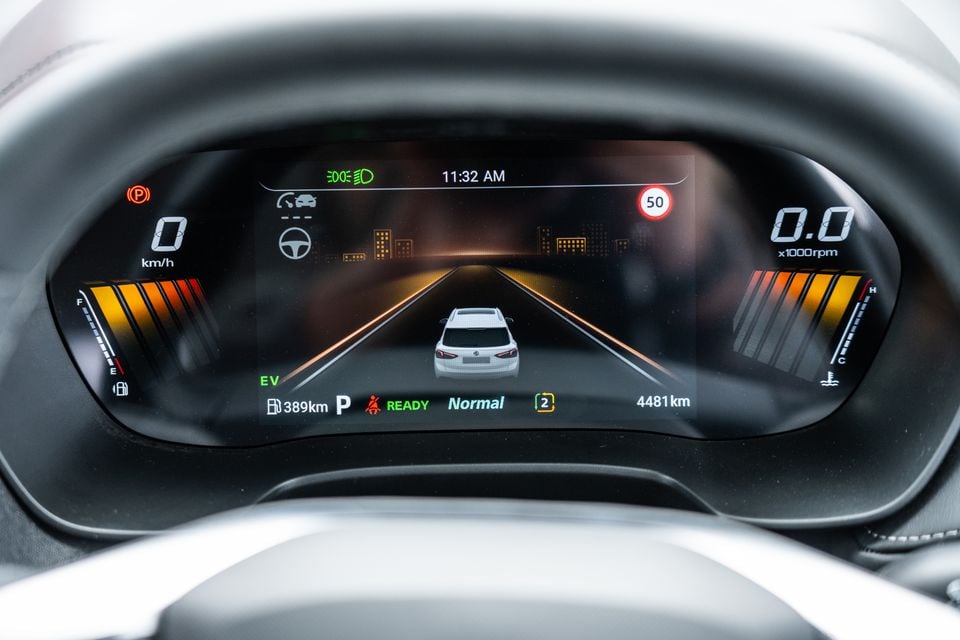 Digital instrument cluster of the 2026 MG ZS Essence Hybrid showing speed, RPM, fuel range, EV mode, and a 50 km/h speed sign warning