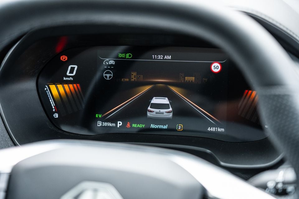 Digital instrument cluster of a 2026 MG ZS Essence Hybrid showing speed, EV mode, fuel range, and a 50km/h speed sign on the display