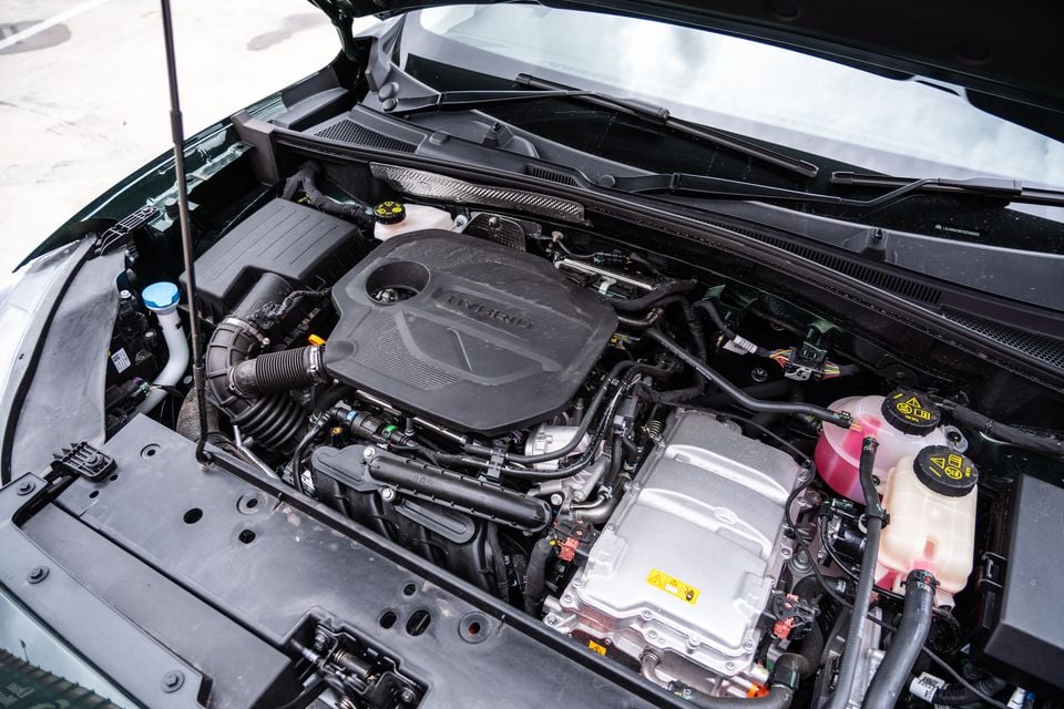 Engine bay of a 2026 MG ZS Essence hybrid, with the hood open showing the hybrid engine cover and electric motor components