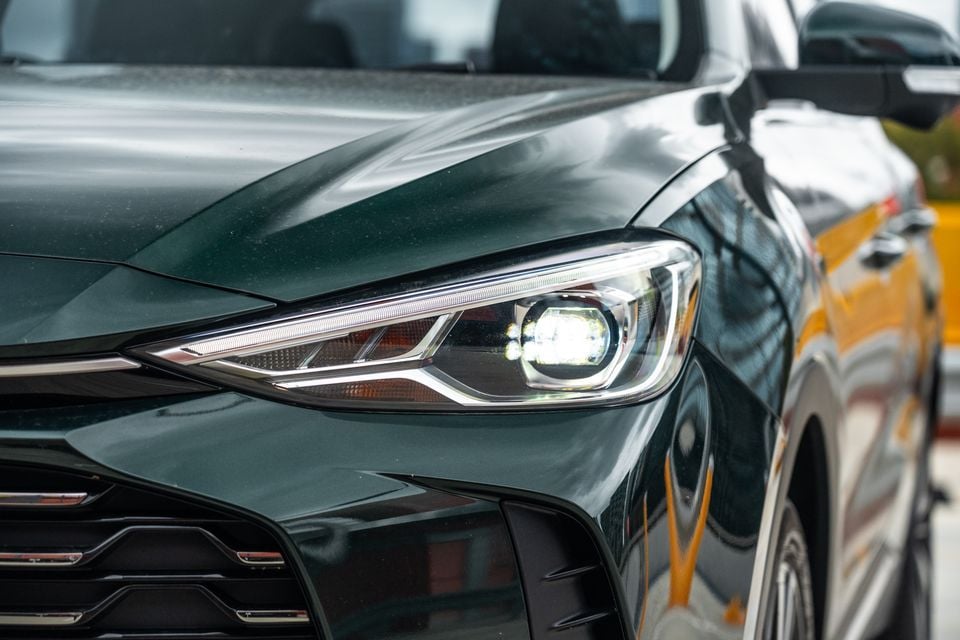 Close-up of the LED headlight on a dark green 2026 MG ZS Essence Hybrid