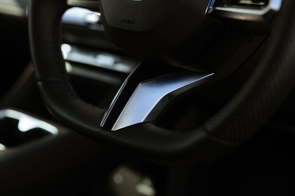 Close-up of the steering wheel centre spoke and badge detail inside the 2026 MG4 Urban EV