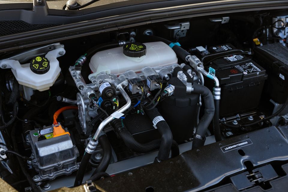 Engine bay of a 2026 MG4 Urban EV showing electric drive components, wiring, coolant reservoir, and battery