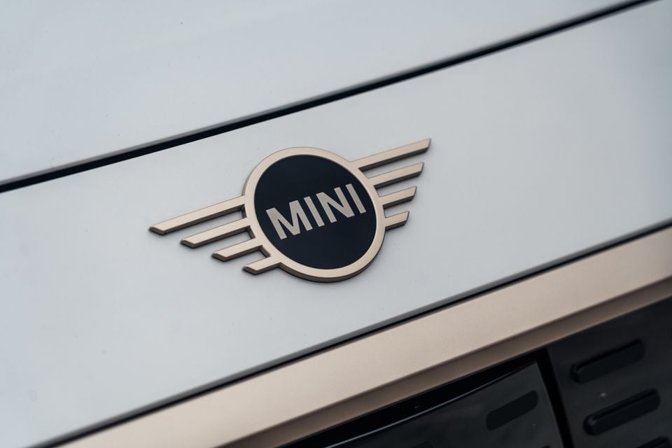 Close-up of the MINI winged badge on the bonnet of a light-coloured MINI Countryman