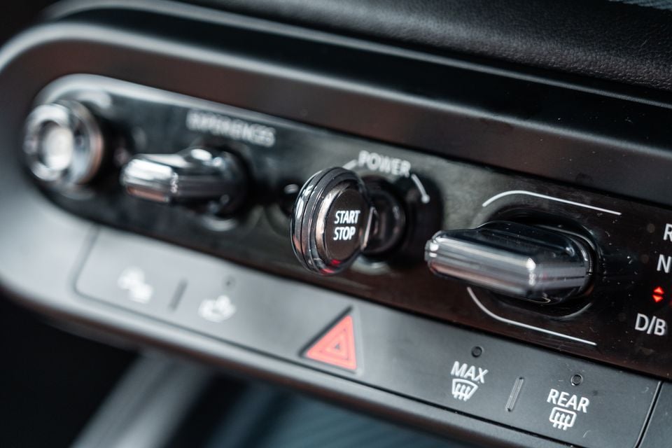 Close-up of the centre console controls in a 2026 Mini Countryman SE Favoured, showing the Start/Stop button, transmission dial, and various switches