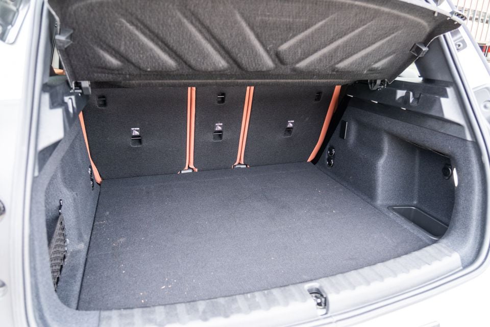 The open boot of a 2026 Mini Countryman SE Favoured, showing a spacious carpeted cargo area with orange seat-folding straps and top-tether anchor points
