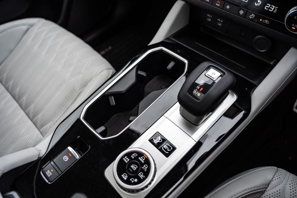 Centre console of the 2026 Mitsubishi Outlander PHEV showing the gear selector, electric park brake, auto hold button, drive mode dial, and climate controls