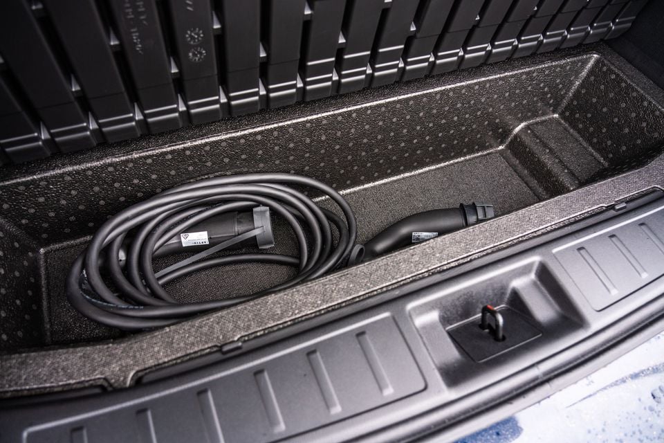 EV charging cable stored in the under-floor boot compartment of a 2026 Mitsubishi Outlander PHEV