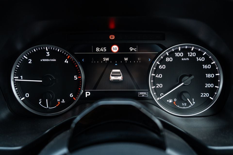 Instrument cluster of the 2026 Mitsubishi Triton GSR with analogue tachometer and speedometer either side of a central digital display showing park