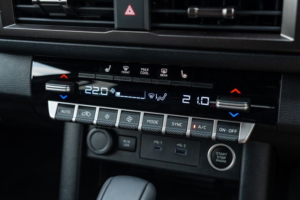 Dual-zone climate control panel with heated seat buttons, USB ports and start/stop button in the 2026 Mitsubishi Triton GSR