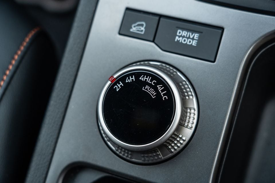 Four-wheel-drive selector dial with 2H, 4H, 4HLc and 4LLc modes and a Drive Mode button on the centre console of a 2026 Mitsubishi Triton GSR