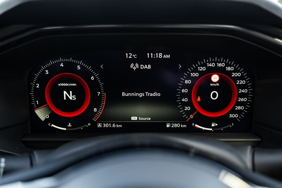 Digital instrument cluster of a 2026 Nissan Z Heritage showing a tachometer, speedometer, DAB radio displaying 'Bunnings Tradio', temperature of 12°C, and a trip distance of 301.6 km.