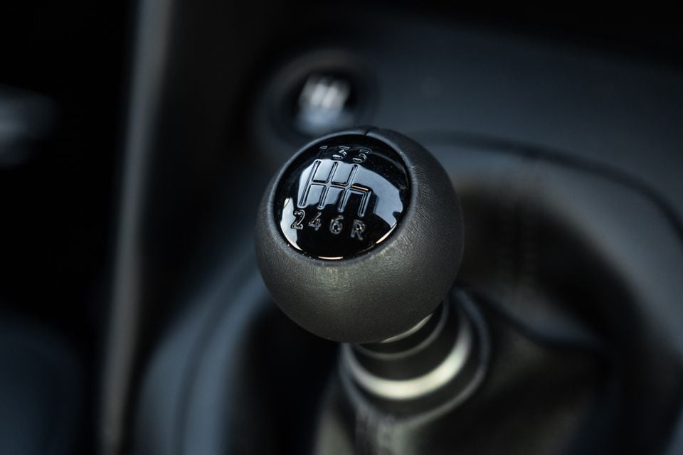 Close-up of a 6-speed manual gear shift knob inside a Nissan Z