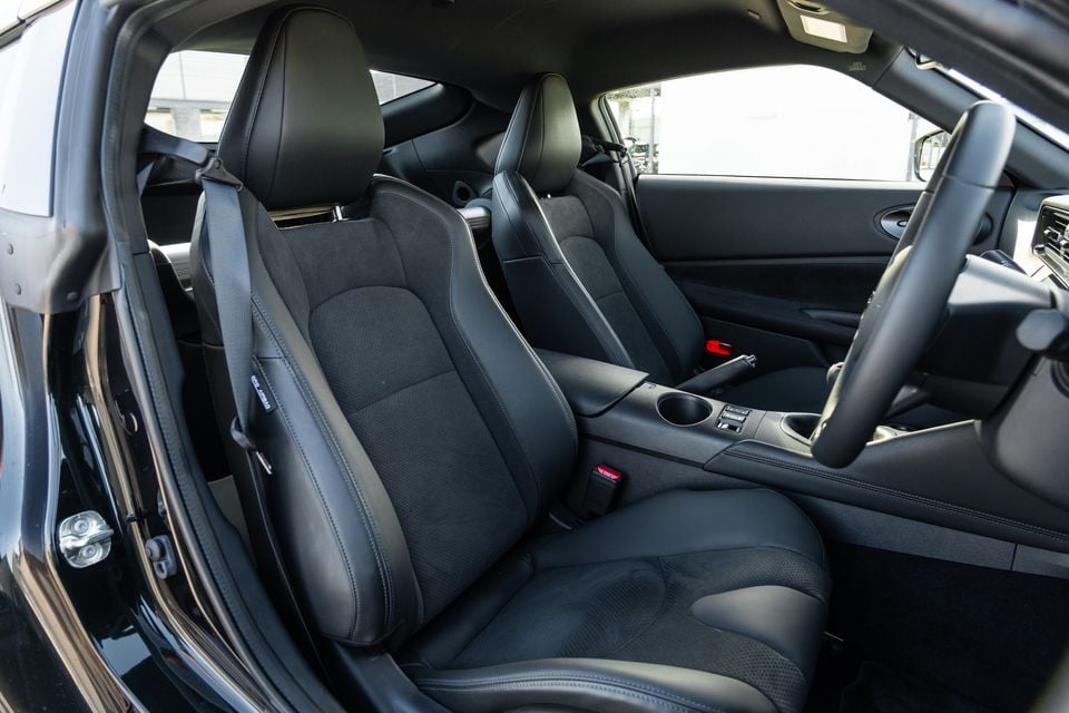 Interior view of a 2026 Nissan Z Heritage 60 showing black sport front seats, centre console, and steering wheel