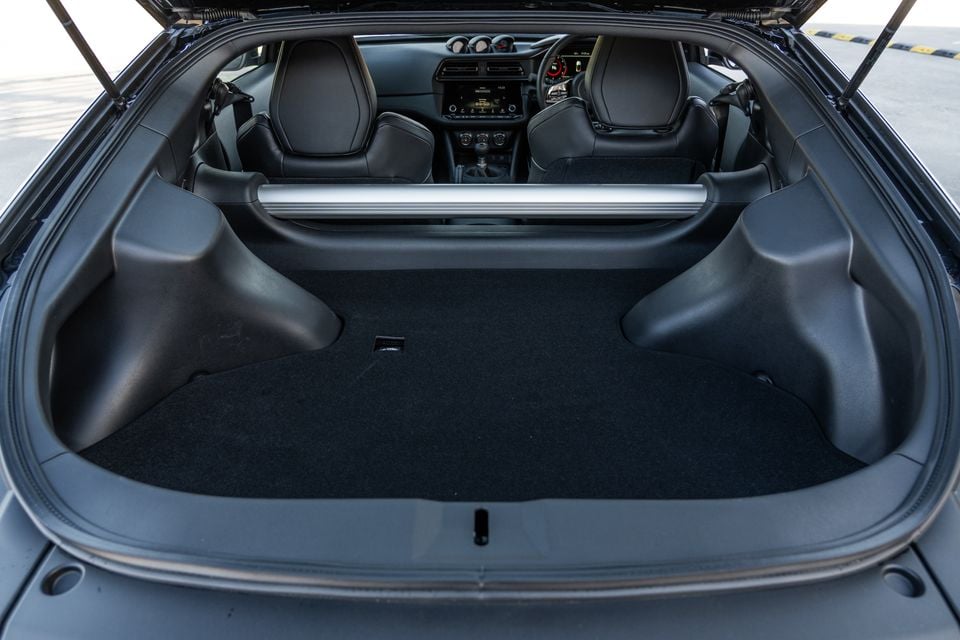 Open boot of a 2026 Nissan Z Heritage edition showing the empty cargo area with black carpet and rear seats visible through the cabin