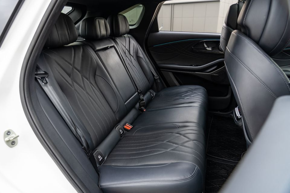 The rear interior of the 2026 Omoda 9 showing black leather rear seats with quilted stitching detail and seatbelts visible